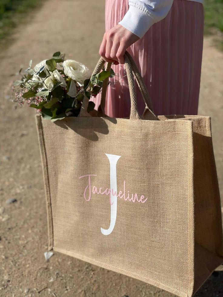 Personalized jute shopping bag featuring large white initial and pastel name text