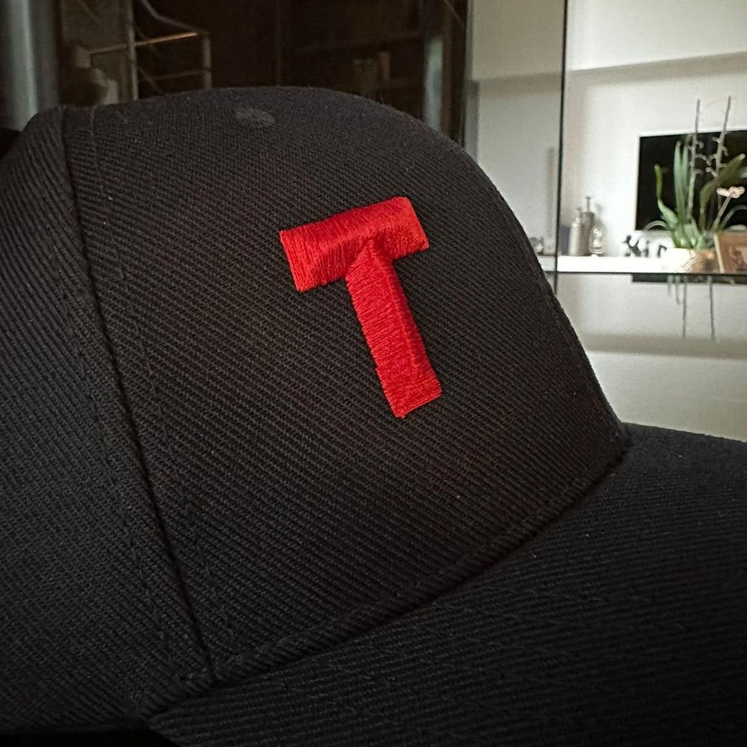 Black cap with a red letter &