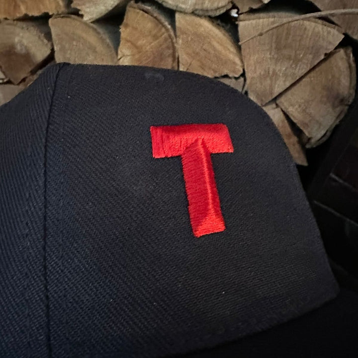 Black fabric with a red letter &