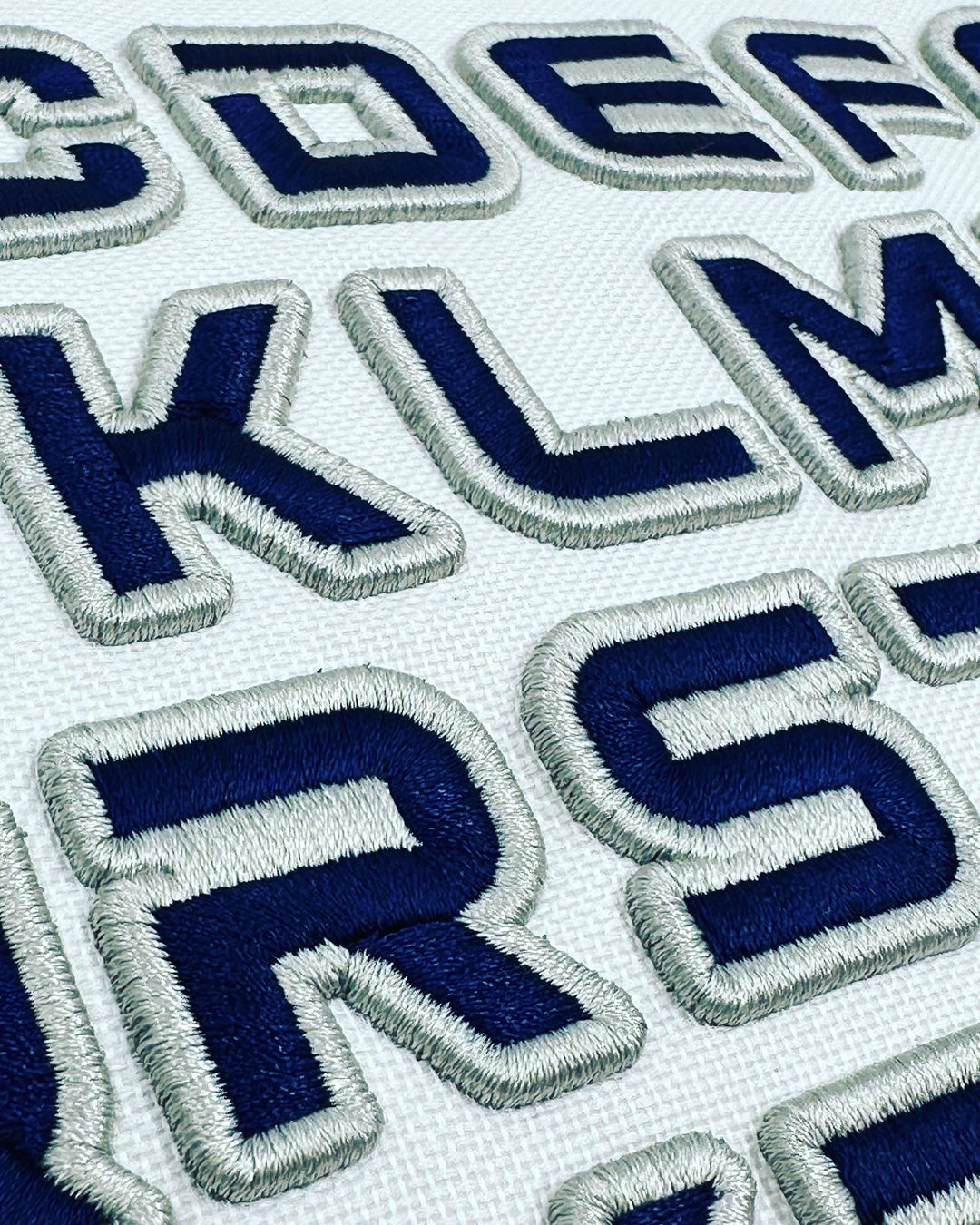 Embroidered letters on a white background