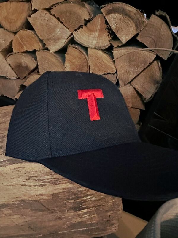 A black baseball cap with the letter &