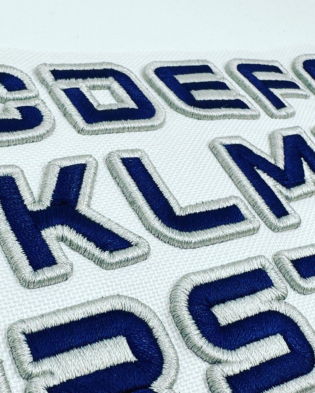 Embroidered letters on a white background