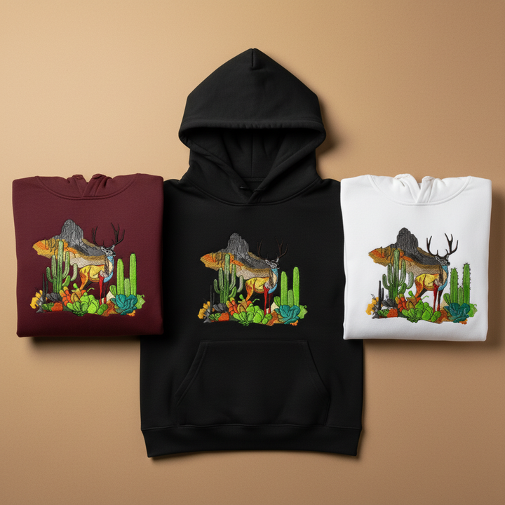 Three hoodies in different colors with a共同的图案 of a deer and cacti design on a beige background.