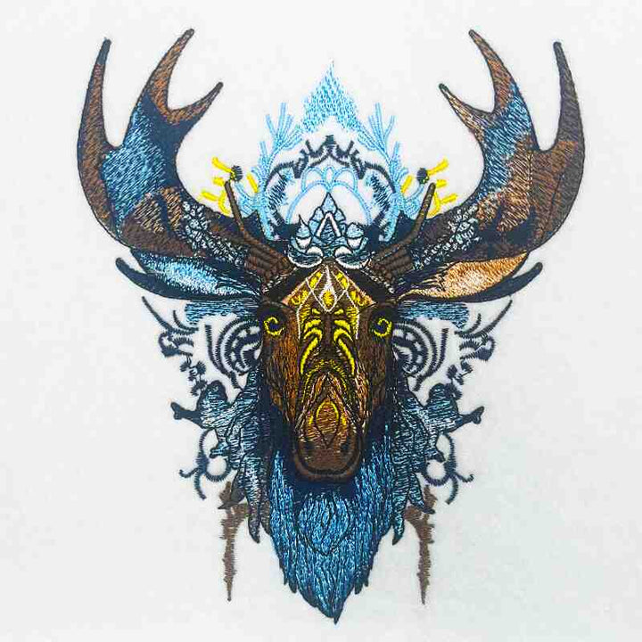 Embroidered sweatshirt featuring a tribal moose design with digital thread elements in blue and gold colors on a white background.