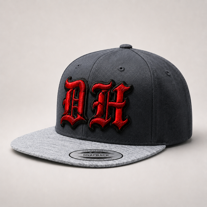 Gray and black snapback cap with red and black logo on a light gray background
