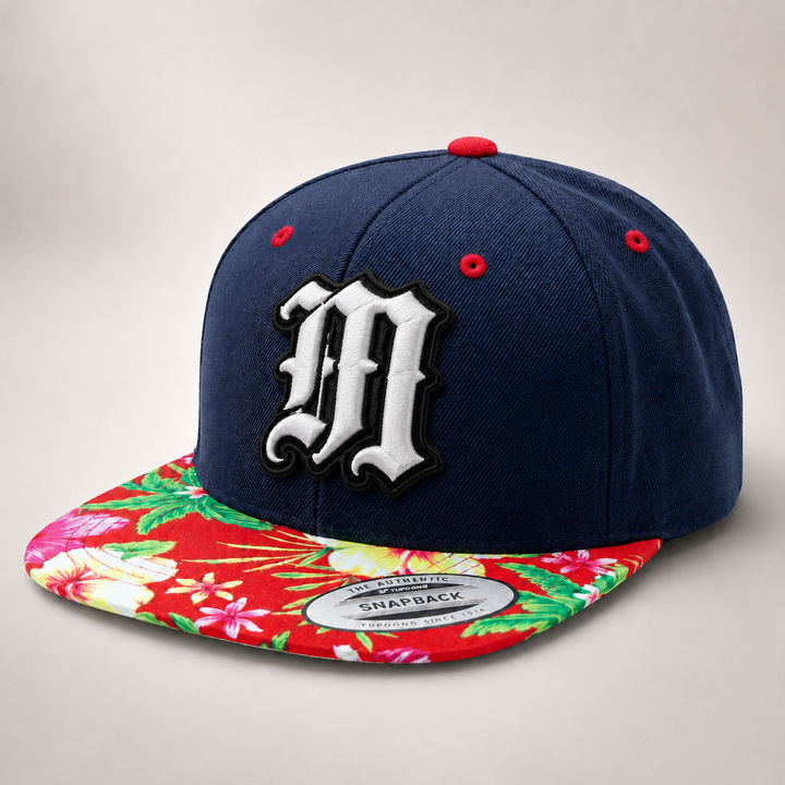 Navy blue snapback cap with floral brim and large white letter &