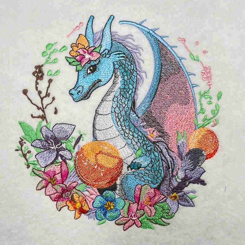 A colorful embroidered picture featuring a dragon surrounded by floral motifs.