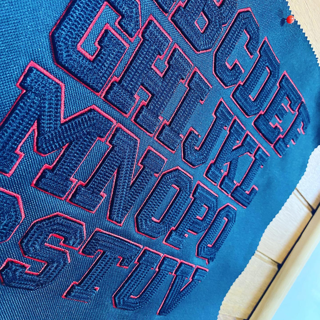 Blue shoe with red text and patterns on a light blue background