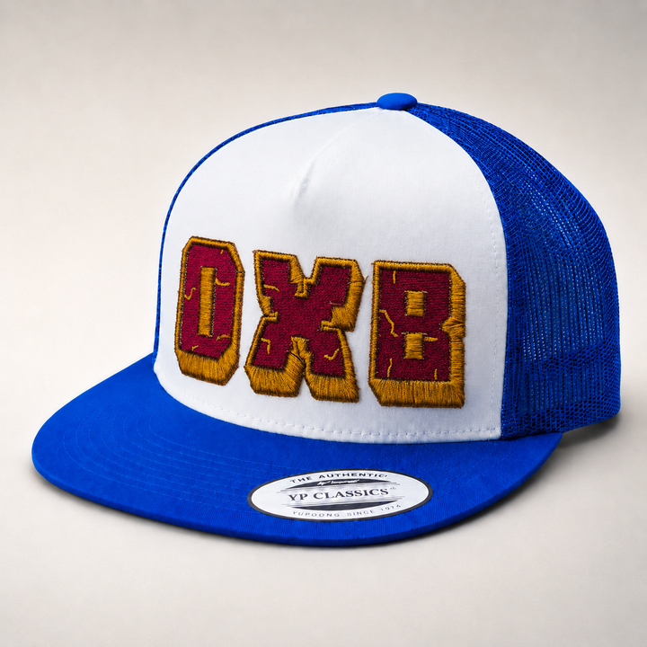 Blue and white cap with embroidered letters on a light gray background