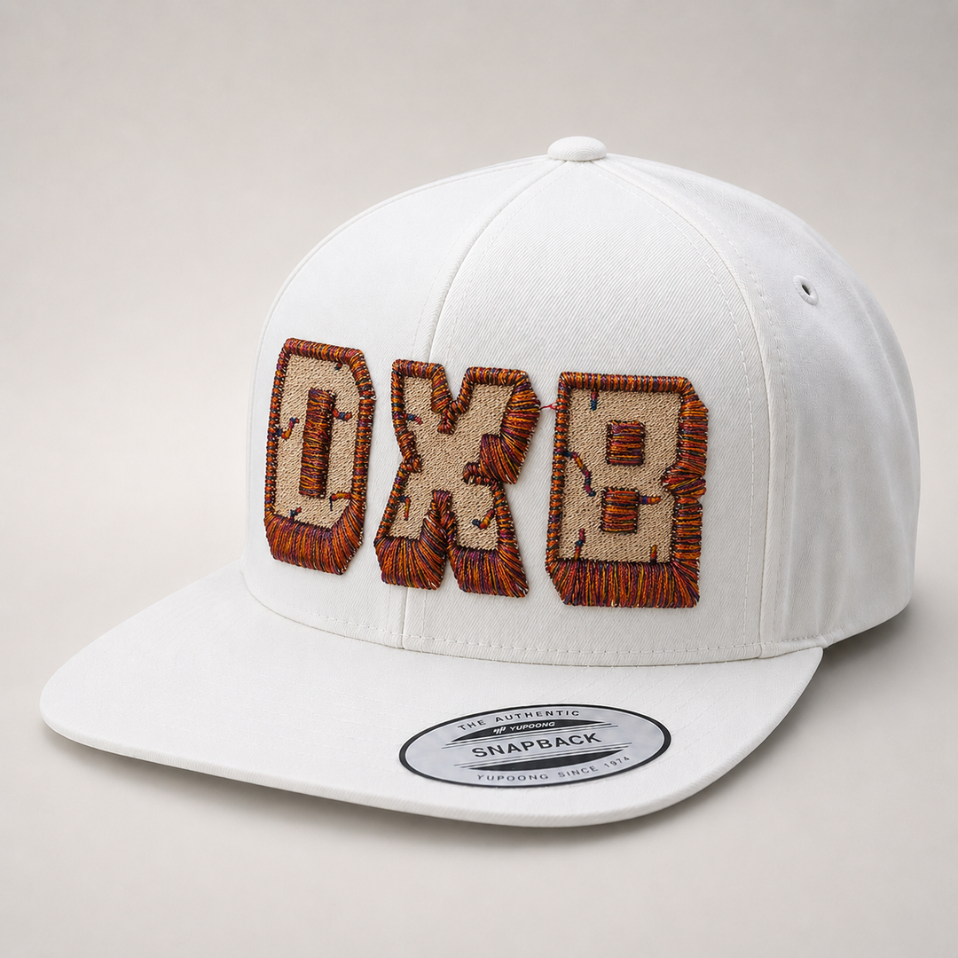 White cap with brown embroidered text on a light gray background