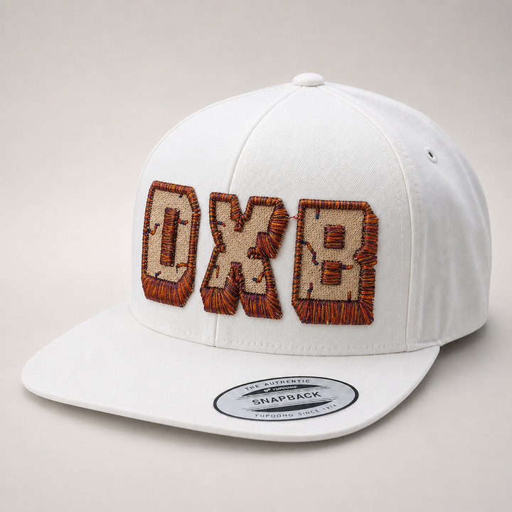 White cap with brown embroidered text on a light gray background