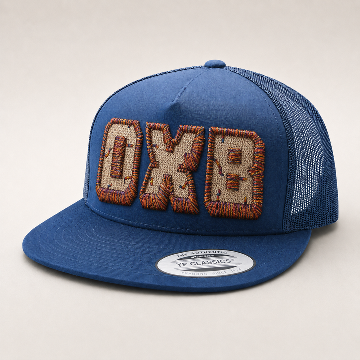 Blue cap with embroidered text on a light gray background