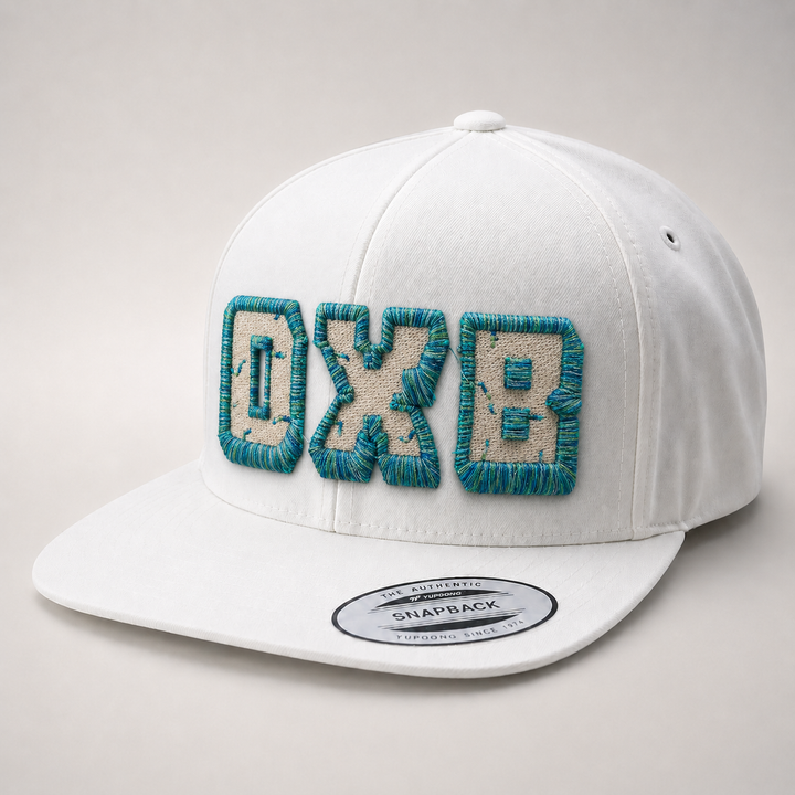 White cap with teal and beige text on a light gray background