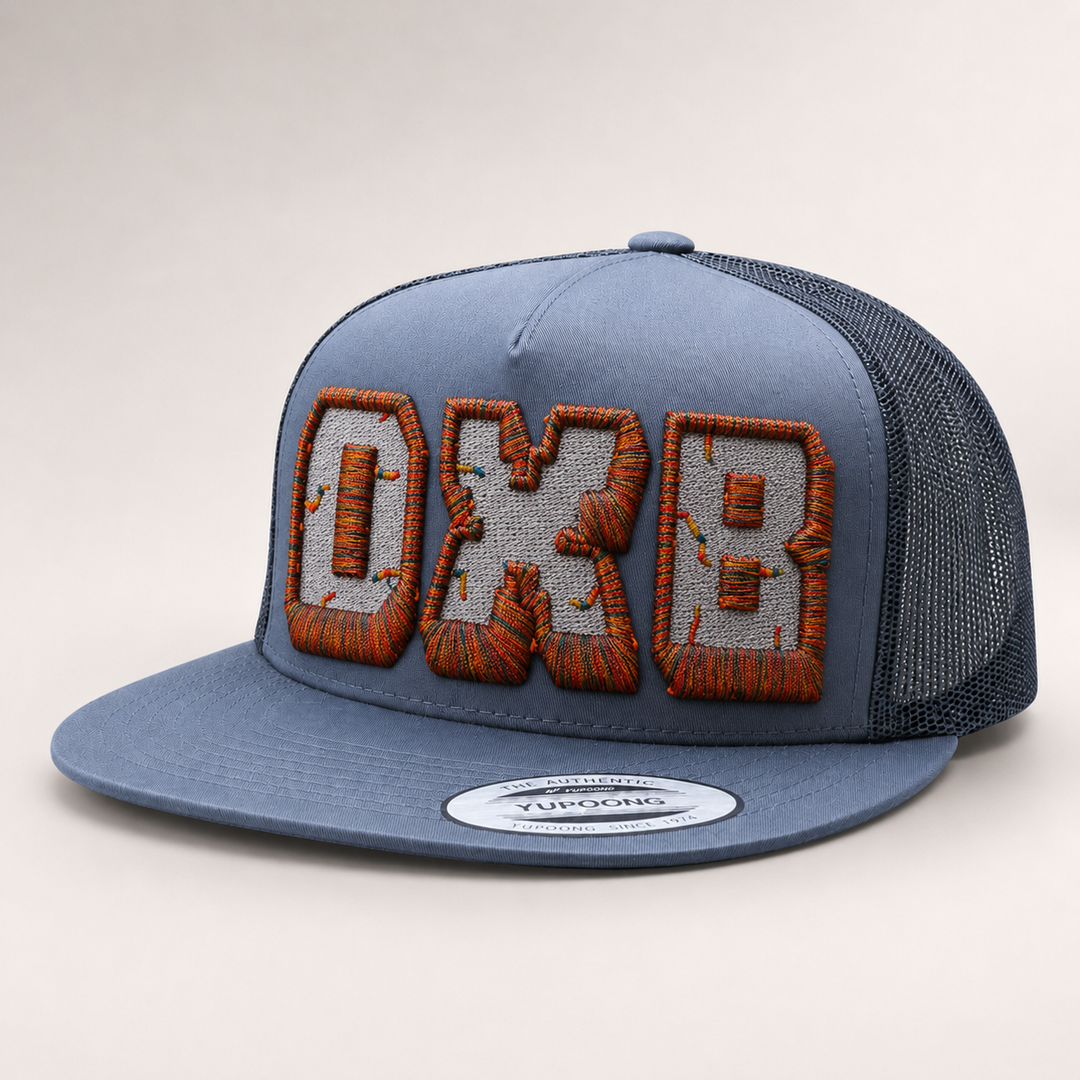 Blue trucker cap with embroidered logo on a light gray background