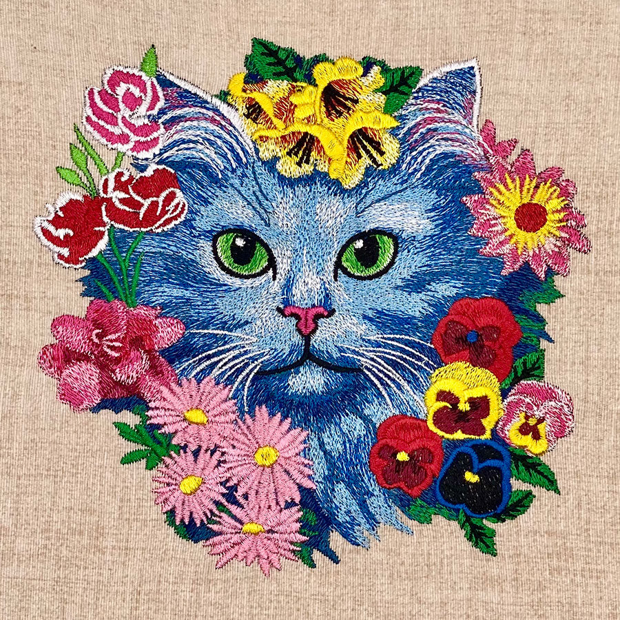 Embroidered design  featuring a realistic cat face surrounded by colorful floral designs on the front.