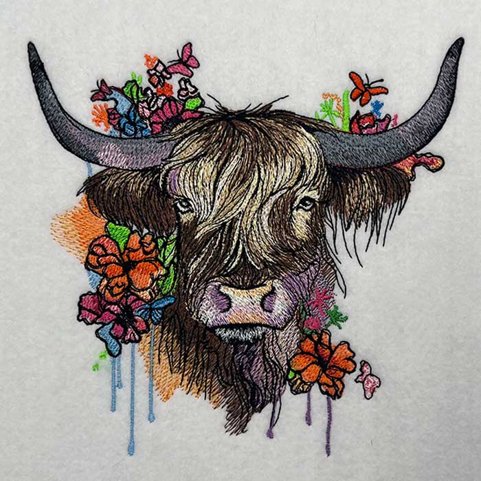 Embroidered design  featuring a floral design with a Highland cow and various plants.