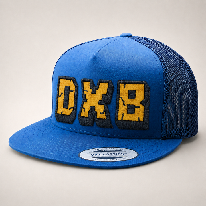 Blue cap with yellow and black text on a light gray background