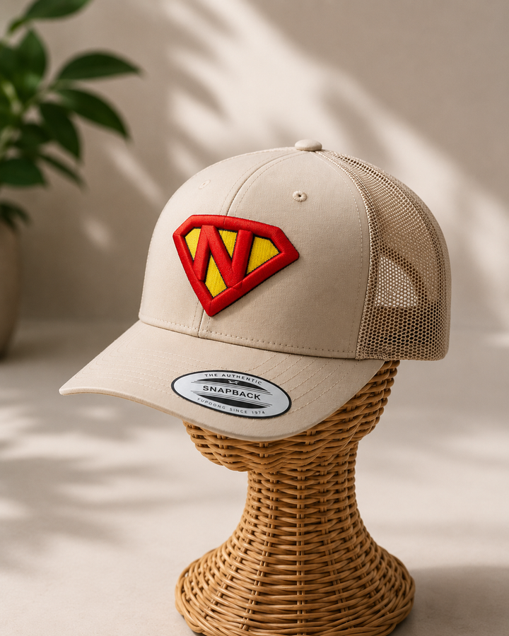 HeroShield Custom Initial Cap – Lifestyle Gifting Shot on Wicker Stand | Machine Embroidered in Dubai | EmbroMania
