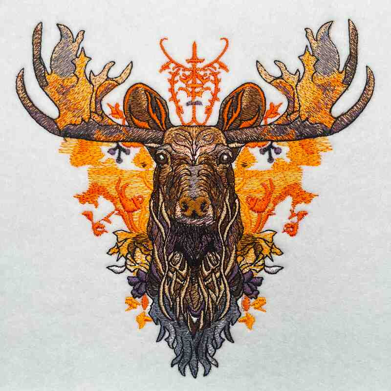 A detailed embroidered design of an orange moose with fiery gradients and geometric patterns, set against a white background.