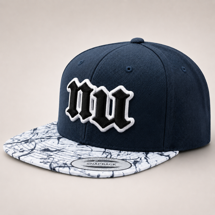 Navy blue snapback cap with white logo on a marble-patterned brim against a beige background