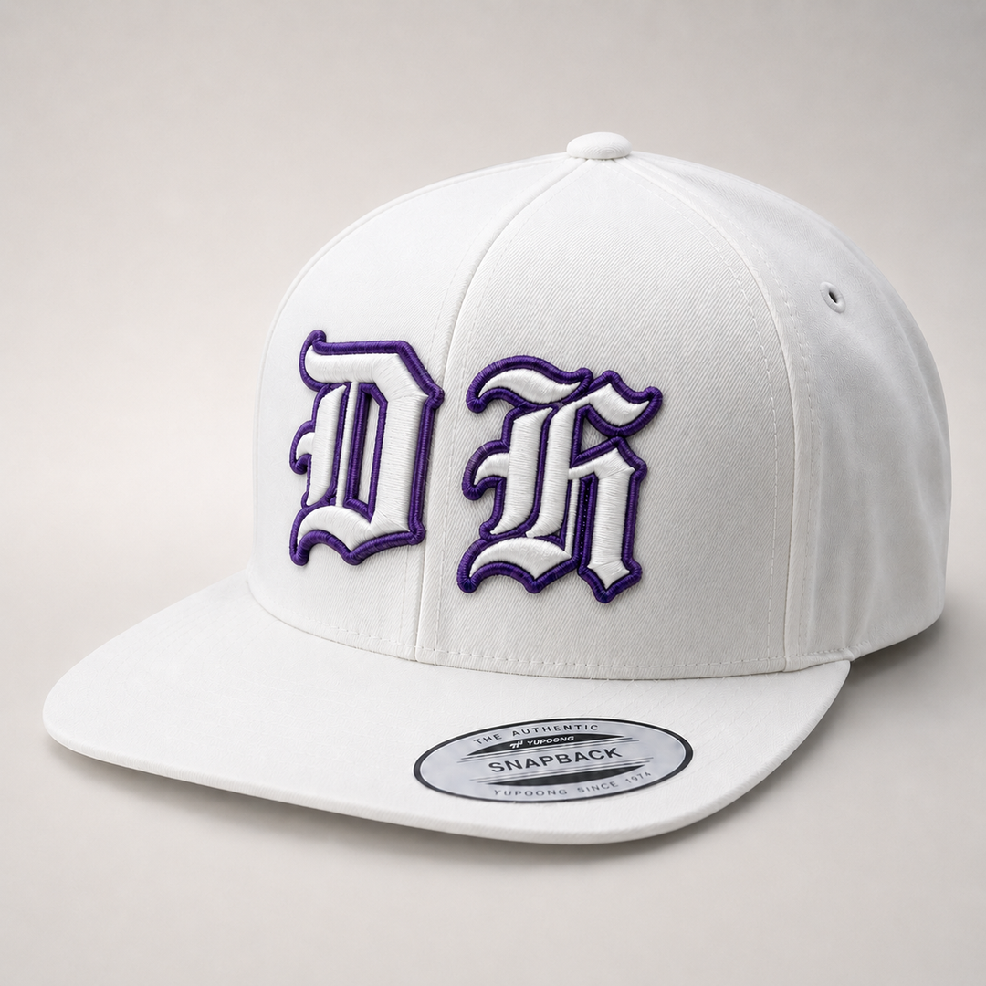 White snapback cap with purple and black logo on a light gray background