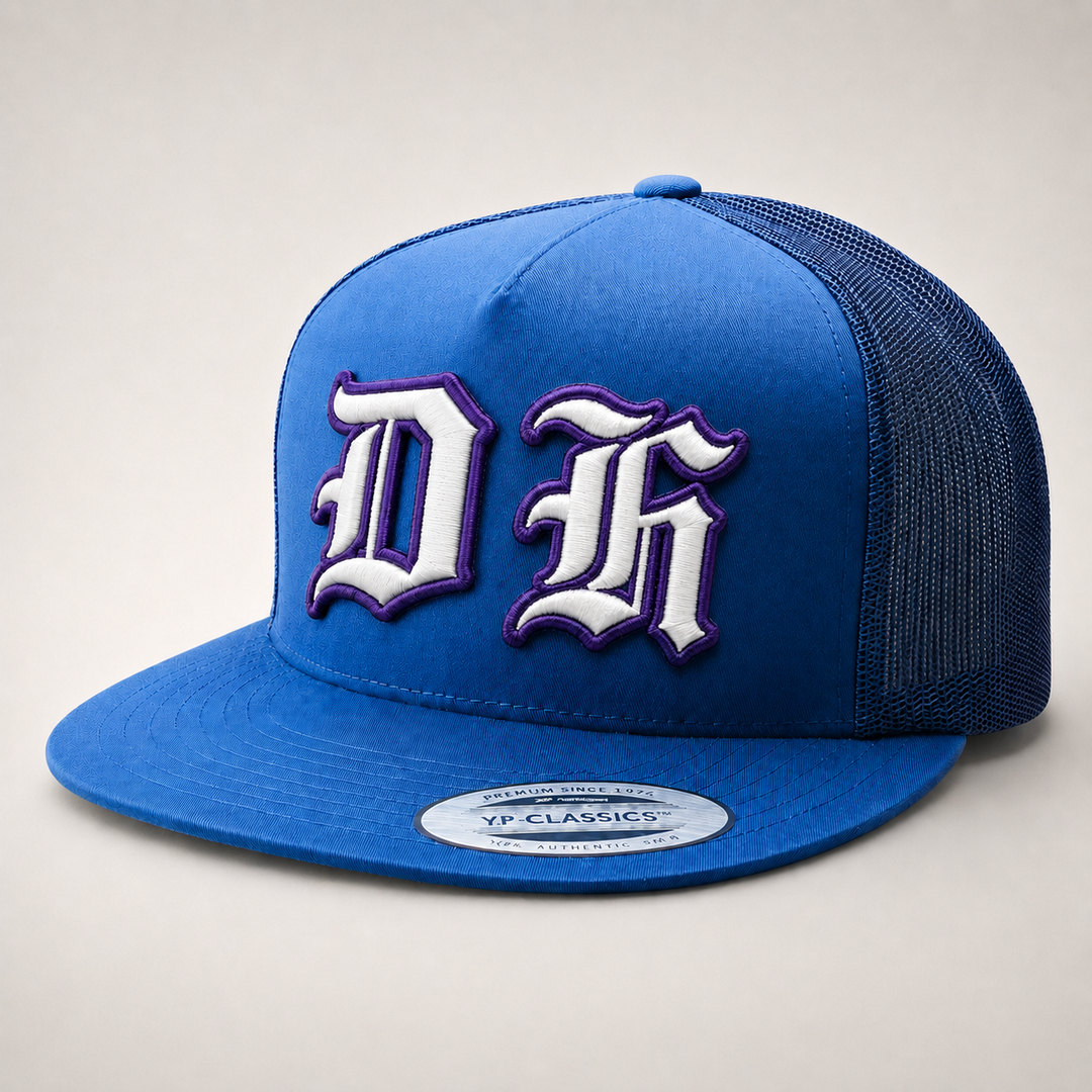 Blue trucker cap with white and purple logo on a light gray background