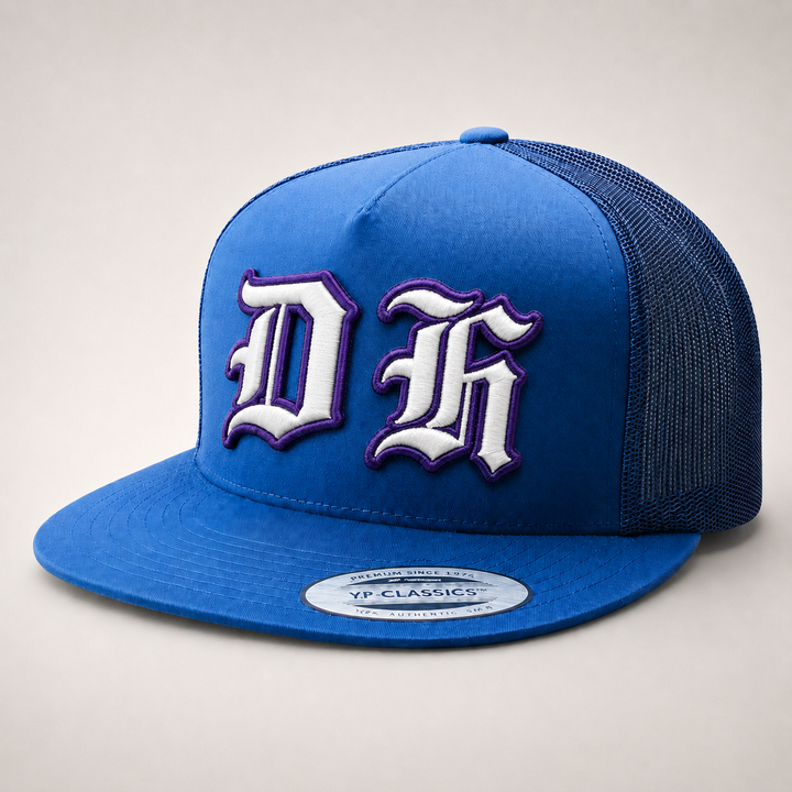 Blue trucker cap with white and purple logo on a light gray background