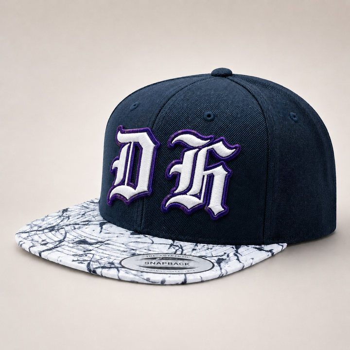 Navy blue snapback cap with white and purple logo on a beige background