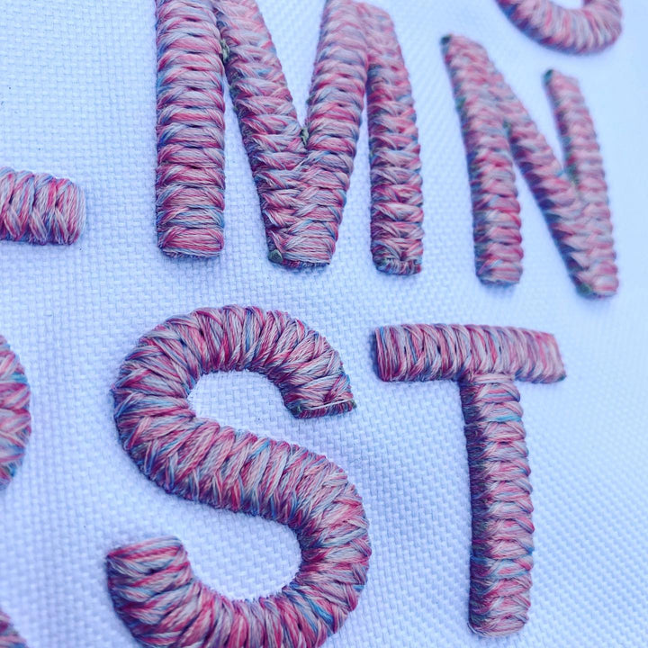 Colorful yarn letters spelling &