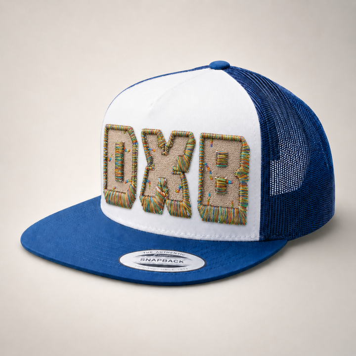 Blue and white trucker hat with embroidered text on a beige background