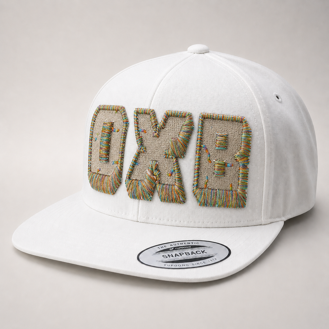 White cap with embroidered text on a light gray background