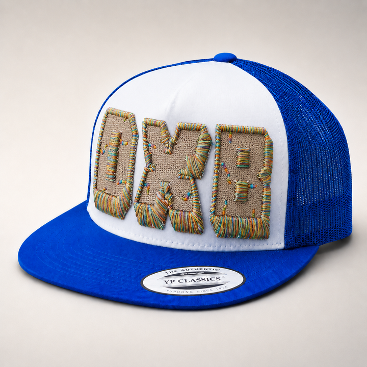 Blue and white trucker hat with decorative text on a light gray background