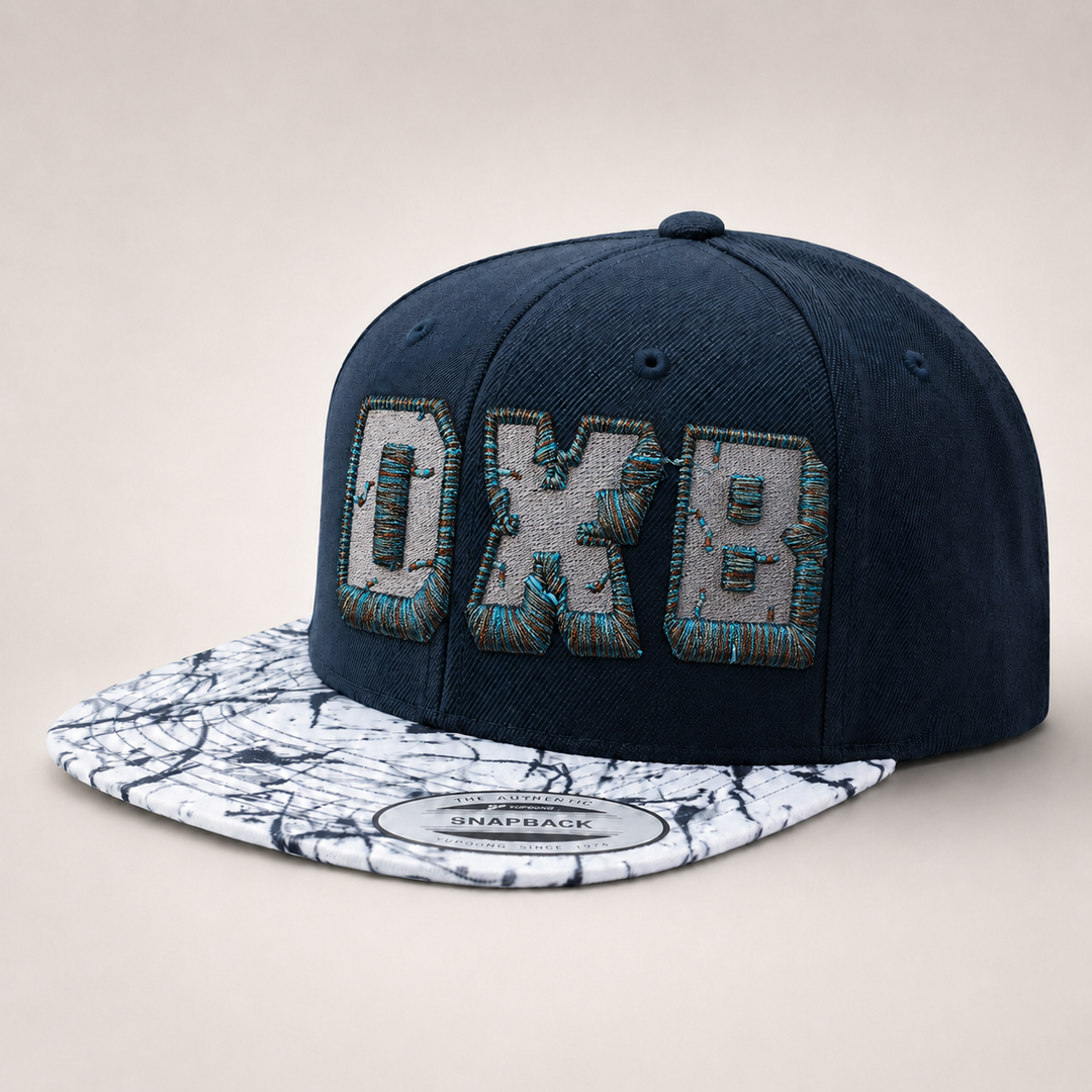 Navy blue snapback cap with marble-patterned brim on a light gray background