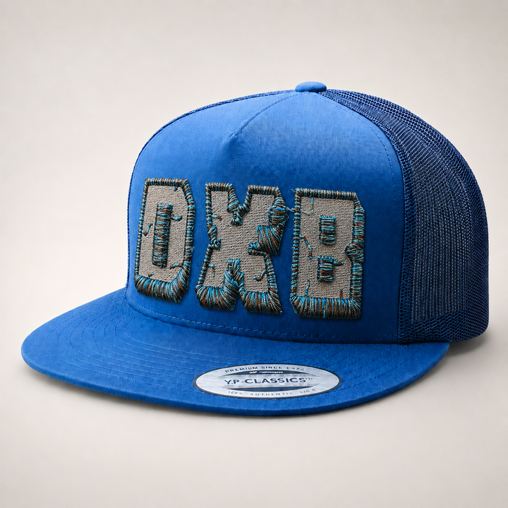 Blue cap with embroidered text on a light gray background