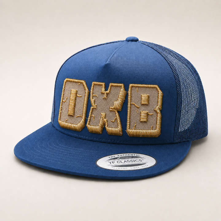 Blue cap with gold embroidered letters on a beige background