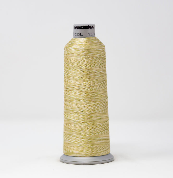 Spool of yellow thread with a visible brand label on a white background