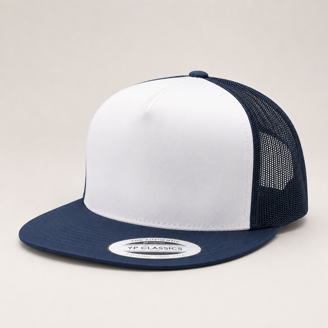 White and navy blue trucker cap with mesh back on a light gray background