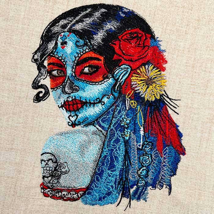 Embroidered sweatshirt featuring a floral portrait of a woman with flowers representing strength and resilience.