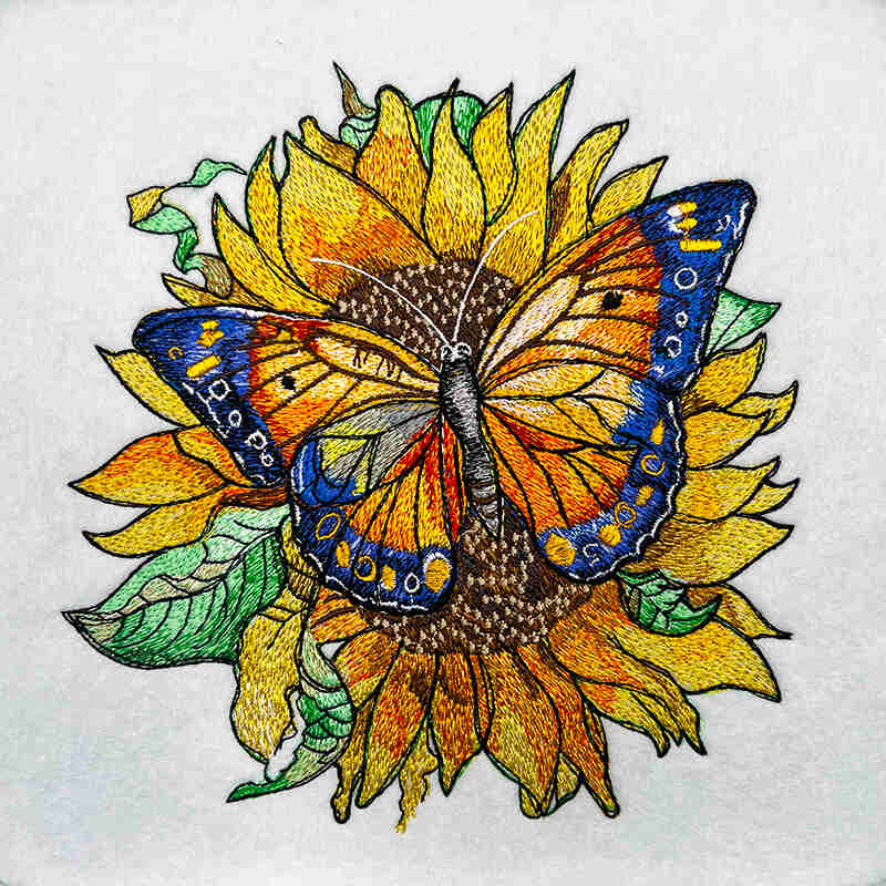 Embroidered jute tote bag featuring a sunflower and butterfly design.