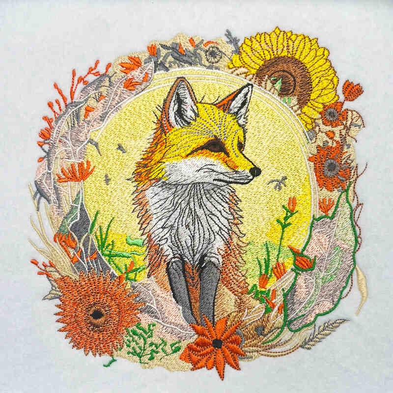 Embroidered design of a fox surrounded by flowers on a white background