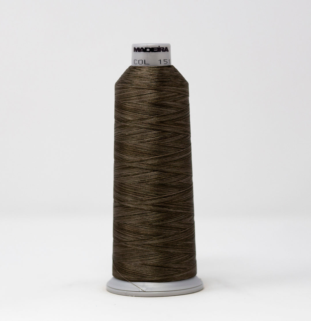 Spool of brown thread with a visible brand label on a white background