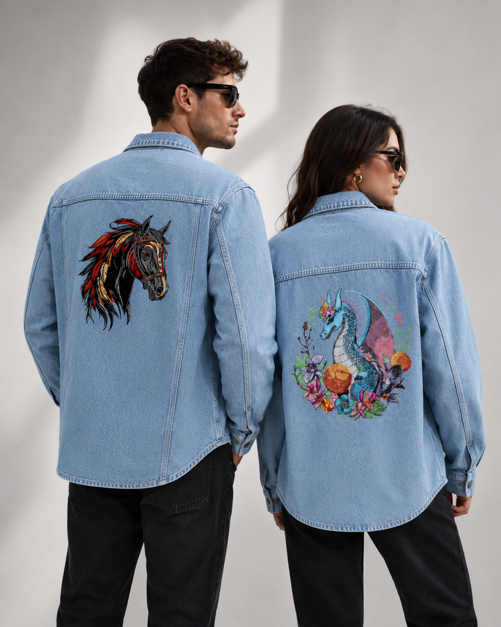 Two people wearing denim jackets with colorful designs on a gray background