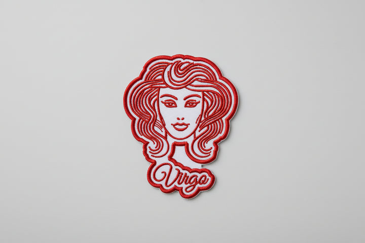 Virgo zodiac maiden embroidery patch featuring a stylized maiden portrait with flowing hair in red outline stitching and the word “Virgo” in script below, on a light background, original EmbroMania artwork.