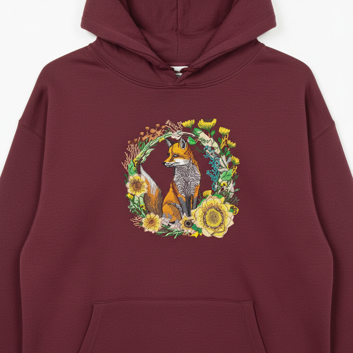 Maroon hoodie with a fox and floral design on a white background