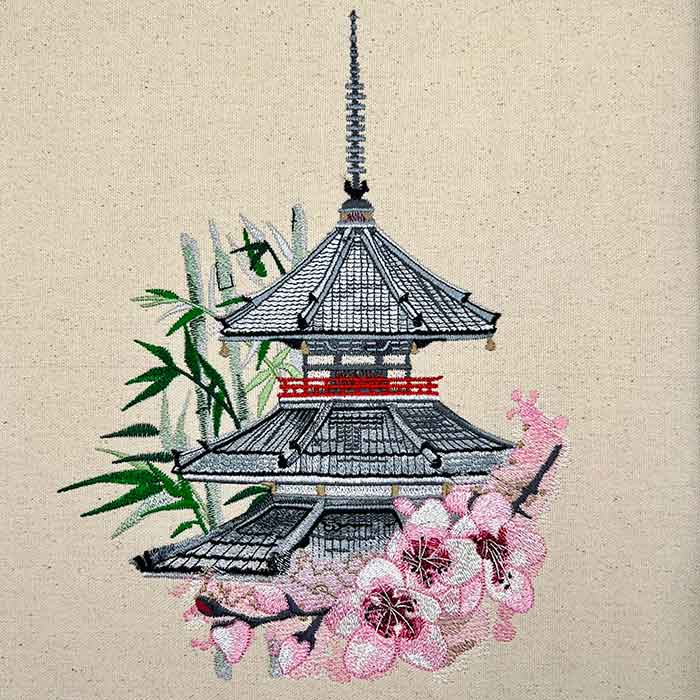 An embroidered design featuring a pagoda and cherry blossoms design.