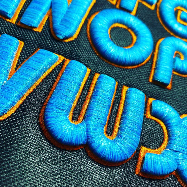 Bubble Pop 3D Puff – Chunky Rounded Letters Close-Up · Royal Blue fill · Gold outline · Bold 3D Puff Texture Detail | Hand Finished in Dubai | EmbroMania