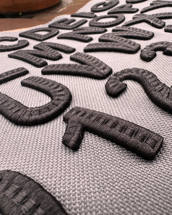 CenterCross Stitch 3D Puff – Cross-Hatch Letter Texture Close-Up Detail · Artisanal X-Pattern Fill | Hand Finished in Dubai | EmbroMania