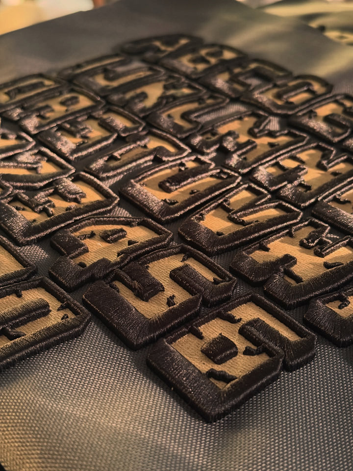 Cracked 3D Puff embroidery texture detail showing raised foam layers and solid fill | Hand Finished in Dubai | EmbroMania