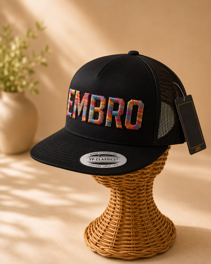 🌈 Carnival – Metro Block 3D Puff · Red orange yellow teal blue purple multicolour · Black flat trucker | Hand Finished in Dubai | EmbroMania