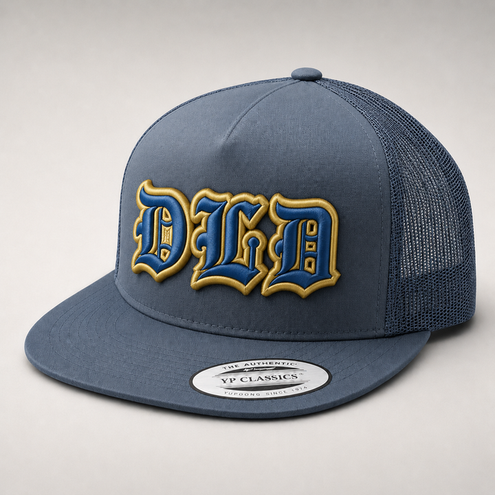 💙 Royal Blue Gold – Old English 3D Puff · Royal blue fill · Gold puff outline · Slate blue flat trucker | Hand Finished in Dubai | EmbroMania